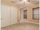 Bedroom with double door closet and neutral carpeting at 6857 W Juana Dr, Peoria, AZ 85383