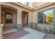 Front entry with a covered walkway and a red door at 6857 W Juana Dr, Peoria, AZ 85383