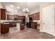 Kitchen with dark wood cabinets, granite counters, and stainless steel appliances at 6857 W Juana Dr, Peoria, AZ 85383