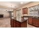 Open kitchen with granite island, stainless steel appliances, and views to living room at 6857 W Juana Dr, Peoria, AZ 85383