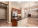 Kitchen with island, stainless steel refrigerator, and views to living room and entry at 6857 W Juana Dr, Peoria, AZ 85383