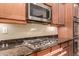 Kitchen with gas cooktop, granite countertops, and stainless steel appliances at 6857 W Juana Dr, Peoria, AZ 85383