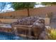 Close-up of the unique waterfall feature in the pool area at 6857 W Juana Dr, Peoria, AZ 85383