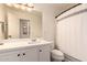 Clean bathroom with a white vanity and shower/tub combo at 6902 S 14Th Dr, Phoenix, AZ 85041