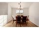 Dining room with hardwood floors and a dark wood table with six chairs at 6902 S 14Th Dr, Phoenix, AZ 85041