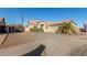 Front view of a single-story house with a two-car garage and desert landscaping at 6902 S 14Th Dr, Phoenix, AZ 85041