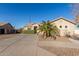 Single-story house with a tan exterior, a palm tree, and a paved driveway at 6902 S 14Th Dr, Phoenix, AZ 85041