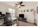 Functional home office with a desk, chair, and TV at 6902 S 14Th Dr, Phoenix, AZ 85041