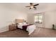 Spacious main bedroom with carpeted floors, a ceiling fan, and large window at 6902 S 14Th Dr, Phoenix, AZ 85041