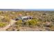 Aerial view of a home with a pool and expansive desert landscape and mountain views at 7002 E Leisure Ln, Carefree, AZ 85377