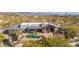 Aerial view of a home with a pool and patio, showcasing the beauty of the desert setting at 7002 E Leisure Ln, Carefree, AZ 85377