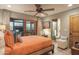 Bright bedroom with orange bedding and access to patio at 7002 E Leisure Ln, Carefree, AZ 85377