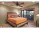 Bedroom with orange bedding and sliding door to patio at 7002 E Leisure Ln, Carefree, AZ 85377