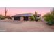 Home's exterior boasts a two-car garage and desert landscaping at 7002 E Leisure Ln, Carefree, AZ 85377