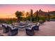 Outdoor fire pit with seating and sunset view at 7002 E Leisure Ln, Carefree, AZ 85377