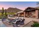 Cozy fire pit with wicker chairs and sunset views at 7002 E Leisure Ln, Carefree, AZ 85377