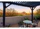 Pergola-covered patio with seating area and stunning desert views at 7002 E Leisure Ln, Carefree, AZ 85377