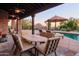 Outdoor dining area with mountain views and a pool in the background at 7002 E Leisure Ln, Carefree, AZ 85377