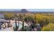 Inviting pool area with a unique curved design, surrounded by desert landscaping and a metal gate at 7002 E Leisure Ln, Carefree, AZ 85377