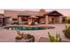 Relaxing kidney-shaped pool with patio seating at 7002 E Leisure Ln, Carefree, AZ 85377