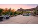 Landscaped backyard oasis with a pool, lounge chairs, and mountain views at 7002 E Leisure Ln, Carefree, AZ 85377