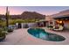 Kidney-shaped pool with lounge chairs, surrounded by desert landscaping at 7002 E Leisure Ln, Carefree, AZ 85377