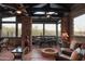 Relaxing sunroom with stone accents,fireplace, and scenic views at 7002 E Leisure Ln, Carefree, AZ 85377