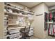 Large walk-in closet with built-in shelves and drawers at 7002 E Leisure Ln, Carefree, AZ 85377