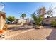 Spacious backyard with brick patio, a fire pit, and lush landscaping at 7135 W Heatherbrae Dr, Phoenix, AZ 85033