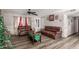 Living room with brown leather couches and wood floors at 7135 W Heatherbrae Dr, Phoenix, AZ 85033