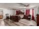 Main bedroom with dark wood furniture and wood floors at 7135 W Heatherbrae Dr, Phoenix, AZ 85033