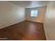 Spacious bedroom with wood-look flooring and large window at 740 W Elm St # 119, Phoenix, AZ 85013