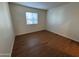 Bright bedroom featuring wood-look flooring and window blinds at 740 W Elm St # 119, Phoenix, AZ 85013