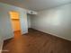 Spacious bedroom with wood-look floors and an adjacent closet at 740 W Elm St # 119, Phoenix, AZ 85013