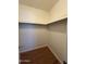 Walk-in closet with wood-look flooring and overhead shelving at 740 W Elm St # 119, Phoenix, AZ 85013