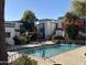 Community pool with waterfall feature and surrounding landscaping at 740 W Elm St # 119, Phoenix, AZ 85013