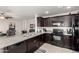 Kitchen with dark wood cabinets, granite countertops, and stainless steel appliances at 790 W Jardin Dr, Casa Grande, AZ 85122