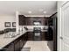 Kitchen with dark cabinets, granite counters, and black appliances at 790 W Jardin Dr, Casa Grande, AZ 85122