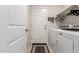 Bright laundry room with washer, dryer, and built-in shelving at 790 W Jardin Dr, Casa Grande, AZ 85122