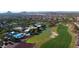 Aerial view of a community with a clubhouse, pool, and golf course at 8047 W Cinder Brook Way, Florence, AZ 85132