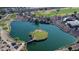 Aerial view of a golf course with a pond and island green at 8047 W Cinder Brook Way, Florence, AZ 85132