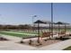 Well-maintained bocce ball courts with shaded seating at 8047 W Cinder Brook Way, Florence, AZ 85132