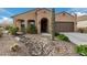 Single-story home with desert landscaping and two-car garage at 8047 W Cinder Brook Way, Florence, AZ 85132