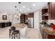 Elegant kitchen with curved island, granite countertops, and stainless steel appliances at 8047 W Cinder Brook Way, Florence, AZ 85132