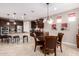 Modern kitchen with dark cabinetry, stainless steel appliances, and an island with seating at 8047 W Cinder Brook Way, Florence, AZ 85132