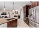 Well-equipped kitchen features a large island, stainless steel appliances, and granite counters at 8047 W Cinder Brook Way, Florence, AZ 85132