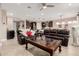 Open concept living area with leather sofas and a view into the kitchen at 8047 W Cinder Brook Way, Florence, AZ 85132