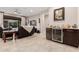 Living room with wine fridge, comfortable seating, and views into the kitchen area at 8047 W Cinder Brook Way, Florence, AZ 85132