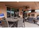 Covered patio with seating area and fireplace at 8047 W Cinder Brook Way, Florence, AZ 85132