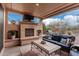 Covered patio features a fireplace and seating area at 8047 W Cinder Brook Way, Florence, AZ 85132